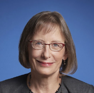 Dr. Meier wearing gray suit against blue background