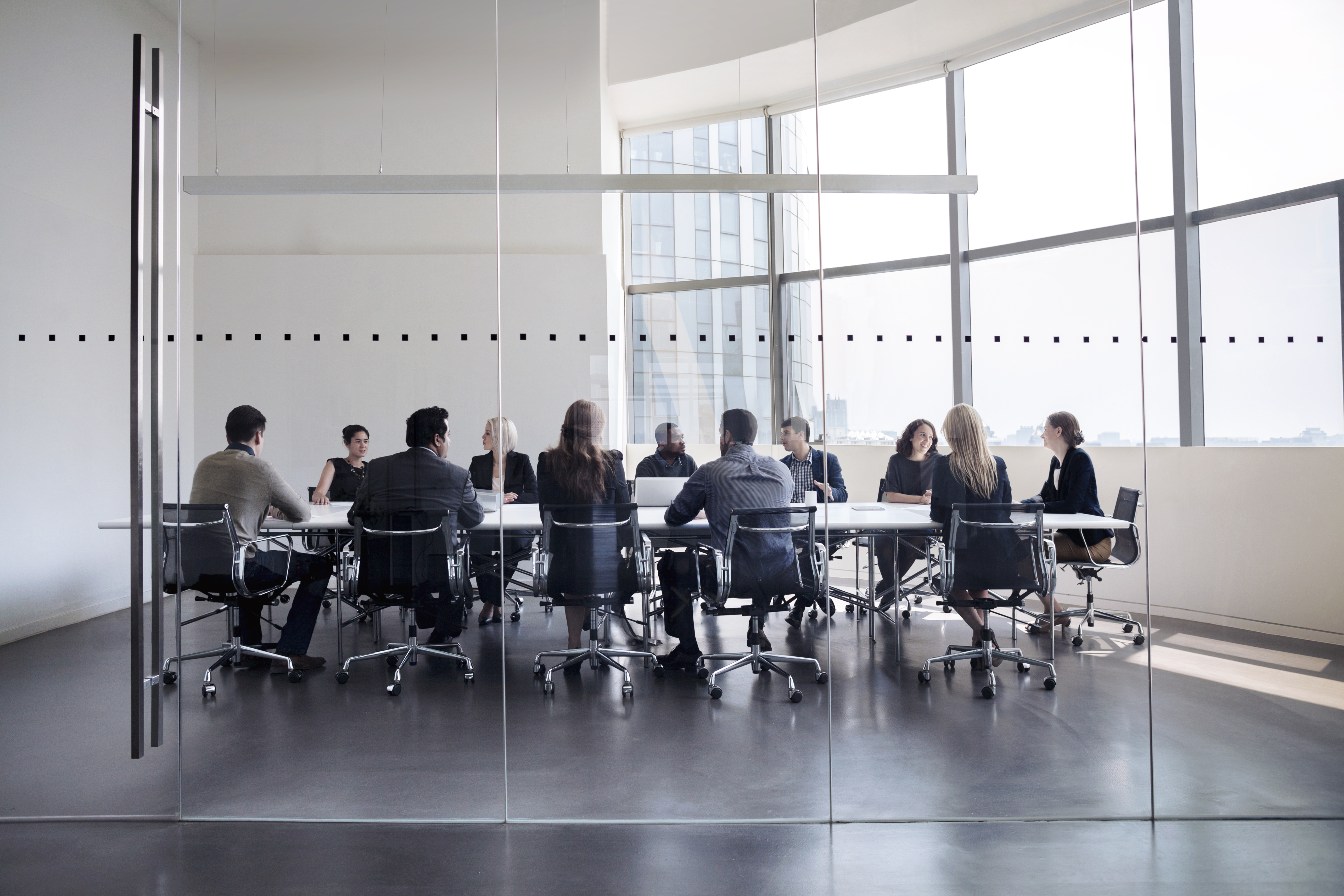 Colleagues at a business meeting in a conference room.