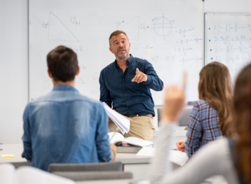 Student raising hand in classroom