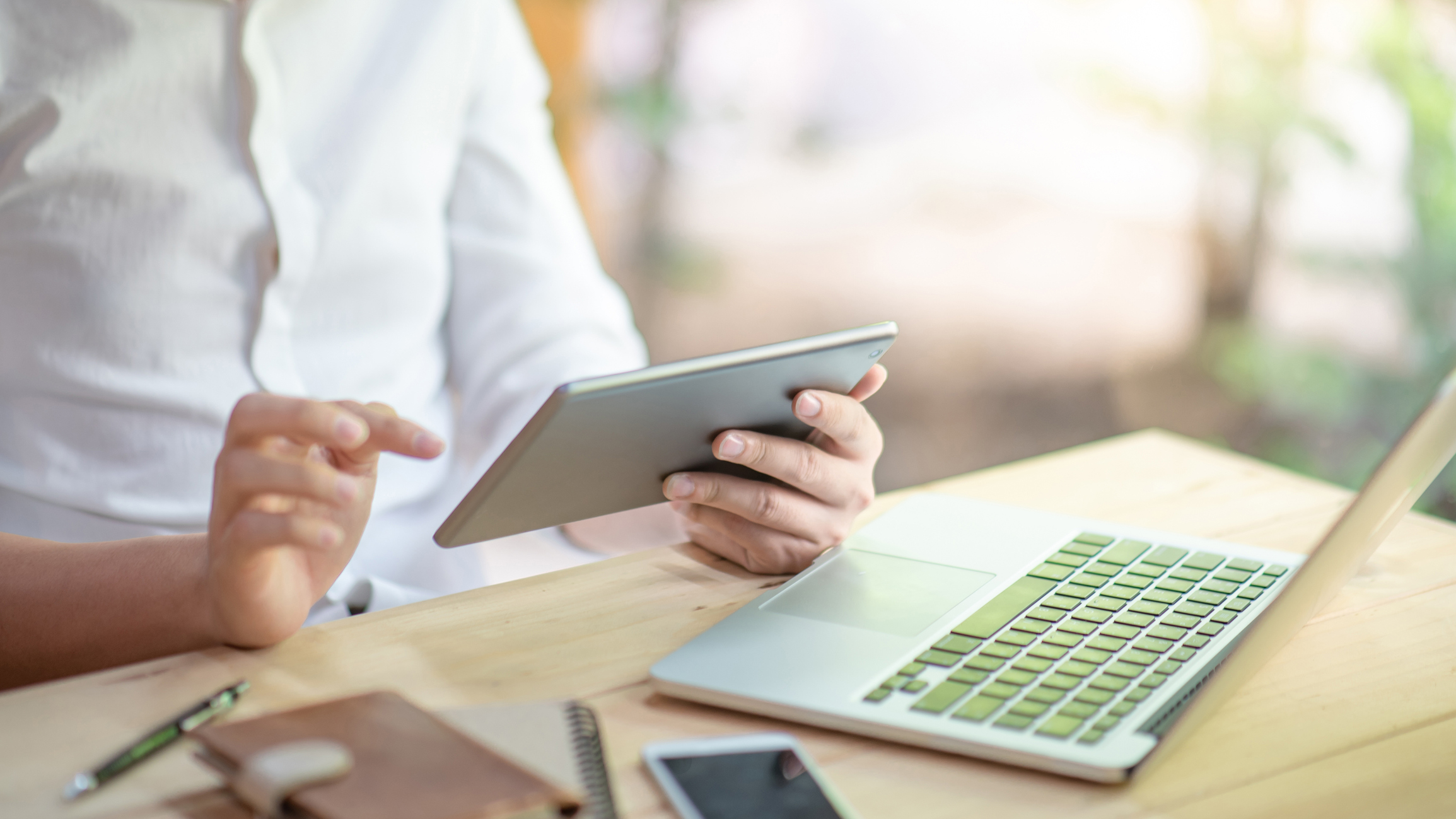 A person using a tablet at a desk