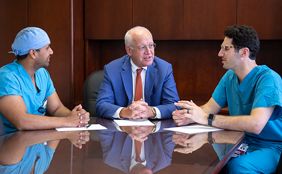 Lawrence B. Colen, MD, center, speaks two residents Jeremy Joseph, MD, left; and Maxwell Wagner, MD, right.